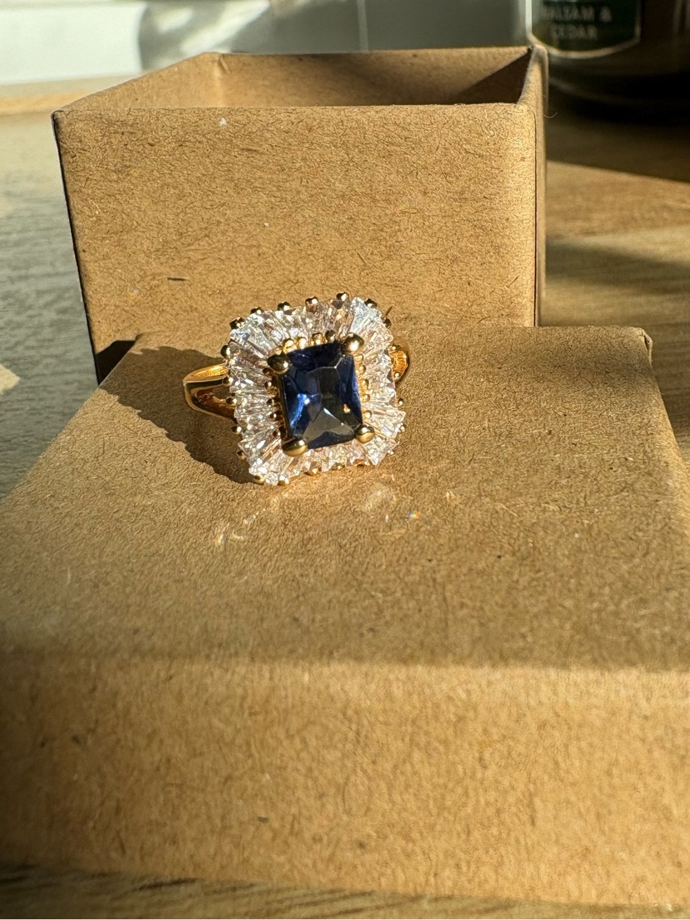 Gold Tone Ring with Navy Center Stone and Halo Accent